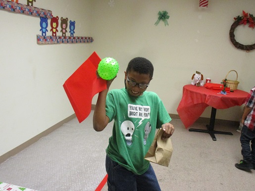 Here is a child showing us his ball and goodies